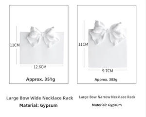 Detailed size chart of two plaster bow jewelry display stands with precise dimensions