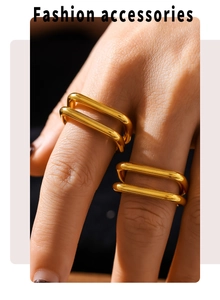Close-up of double-layered hollow U-shaped gold rings on model's fingers