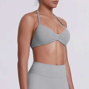 Detail of grey seamless sports bra with neck halter strap and ribbed high waist leggings
