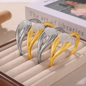 Elegant gold and silver titanium steel bracelets with pavé crystals in a jewelry box