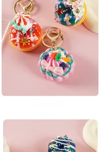 Detail of colorful artificial donut and cupcake keychains with decorative beads
