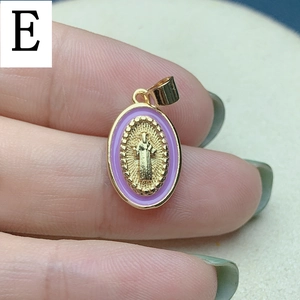Detailed macro view of a lavender enamel and gold religious oval charm pendant