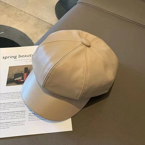 Retro beige faux leather newsboy cap on a magazine background with aesthetic minimal style