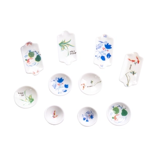 Set of 10 miniature blue and white porcelain plates with hand-painted floral patterns