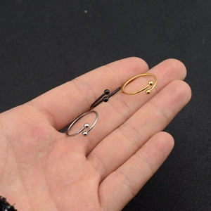 Detailed view of minimalist open rings with beads in gold, silver, and black finish