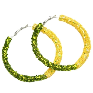 Close-up of oversized hoop earrings featuring green and yellow sequins with silver pins