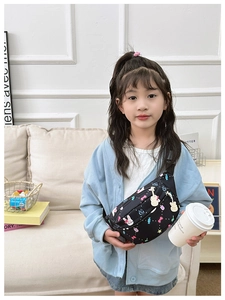 Detail of adjustable black strap and colorful cartoon print on kids chest bag