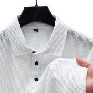Detail of white waffle knit polo shirt showing fabric texture and polo collar close-up
