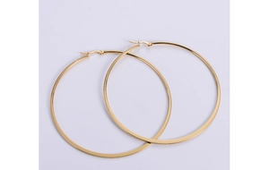 Detail view of large gold titanium hoop earrings with secure mechanical hinge closure