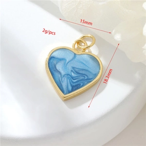 Macro view of 14K gold filled heart pendant with blue marble enamel detail and dimensions