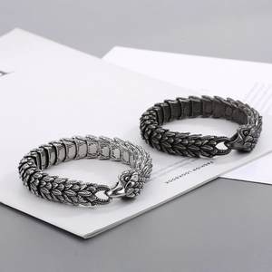 Macro detail of punk eagle head clasp and scale texture on stainless steel bracelet