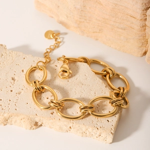 Golden stainless steel O-chain bracelet displayed on a textured stone for a modern look