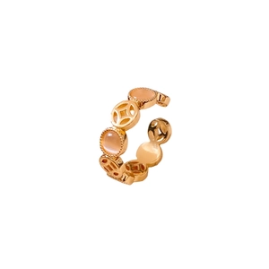 Golden Chinese coin hollow open ring with pink cat eye stone on a clean white background
