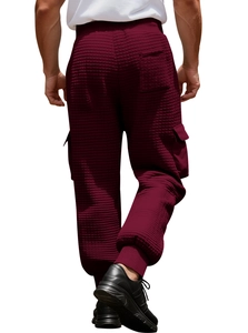 Detail of men's burgundy waffle fabric joggers featuring cargo pockets and elastic cuffs