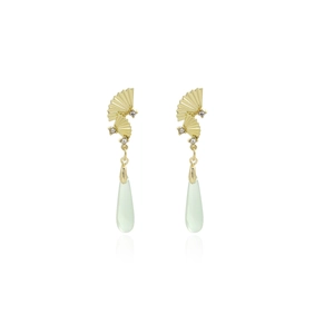 Detail of gold fan-shaped earrings with rhinestones and translucent green water drop pendant