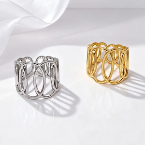 Detail of overlapping oval cutouts on wide gold and silver fashion rings