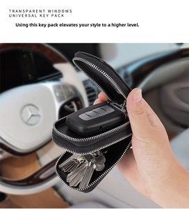 Close-up of double-layer black leather key case with transparent window in car interior