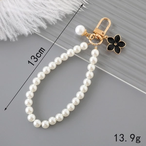 Handmade pearl bag charm with black flower pendant and gold lobster clasp, 13cm length