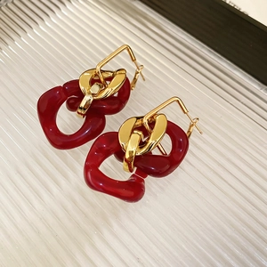 Detailed close-up of retro square resin tassel earrings with polished gold metal finish