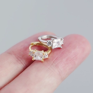 Macro shot of French S925 silver square zircon hoop earrings in gold and silver finishes