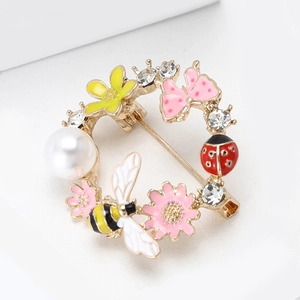 Floral wreath brooch with bee, ladybug, and pearls in a white jewelry gift box
