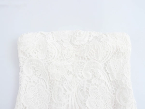 Gros plan sur les motifs complexes de dentelle florale blanche d'une robe de style français
