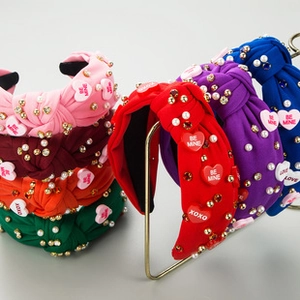 Detail of knotted headbands with rhinestones, pearls and heart charms in multiple colors