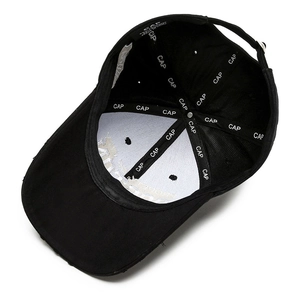 Inside view of black baseball cap with embroidered tape and metal adjustment buckle