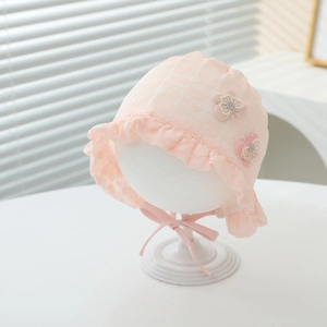 Close-up of pink baby sun hat featuring floral lace details and mesh ruffles