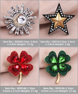 Detailed view of four elegant crystal brooches on pink silk featuring star and clover designs