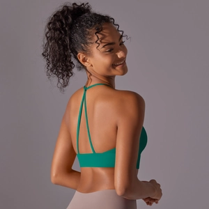Detail of emerald green sports bra featuring a racerback design with thin straps