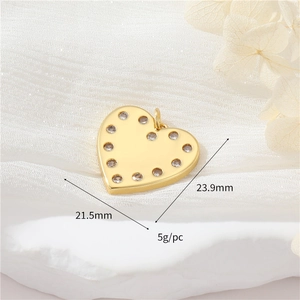 Detailed view of a gold heart pendant with cubic zirconia, dimensions 23.9mm by 21.5mm