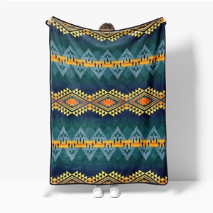Detail of flannel blanket with geometric ethnic patterns featuring mountain motifs