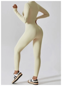 Rear view of cream long sleeve yoga jumpsuit showing slim fit and athletic silhouette