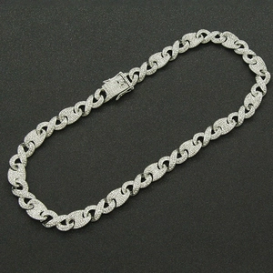Detailed view of silver Cuban link chain with pave set zircons and square buckle