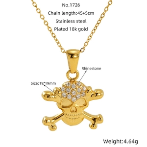 Macro detail of 18k gold plated skull pendant with rhinestones and size specifications