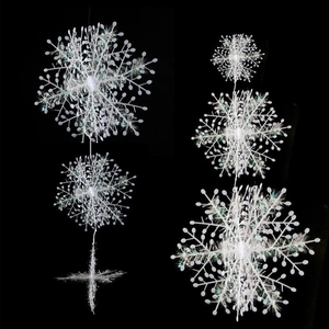 Detailed view of white plastic snowflake garland ornaments for Christmas tree decor