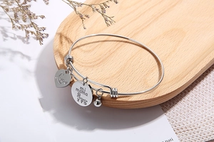 Detail of silver heart bangle with Love mi mama charms and bell for Mother's Day