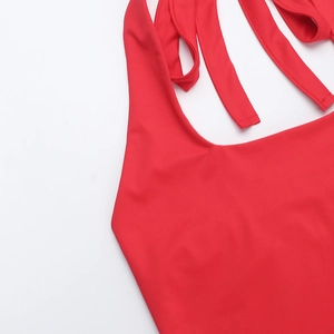 Detailansicht des roten Neckholder-Ausschnitts und der elastischen Stoffstruktur des Kleids
