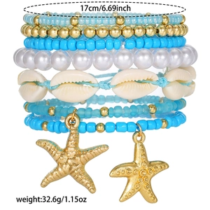 Detail of 7-layer beaded bracelet set featuring sea shells and golden starfish pendants