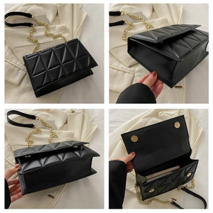 Detail view of black quilted chain bag with magnetic flap and gold-tone hardware