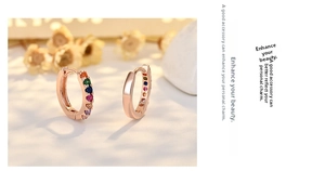 Close-up of rose gold hoop earrings featuring multi-colored rainbow cubic zirconia stones