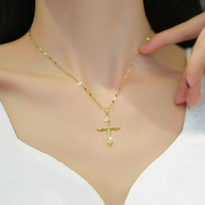 Elegant 18K gold plated stainless steel cross necklace with sparkling cubic zirconia on model