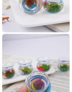 Macro shot of miniature koi fish tank ornaments with resin water and aquatic plants