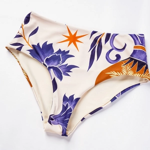 Detailed view of high-waisted bikini bottoms with ethnic floral print and refined stitching