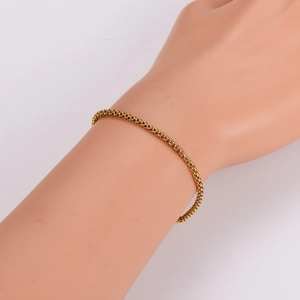 Minimalist gold box chain bracelet for women displayed on a model arm in a high-quality view