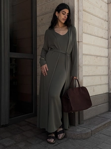 Detail of olive green knit cardigan and maxi dress set with a tied waist and suede bag
