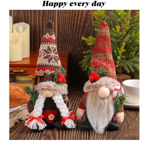 Detailed view of plush Christmas gnomes with snowflake hats and knitted candy cane texture