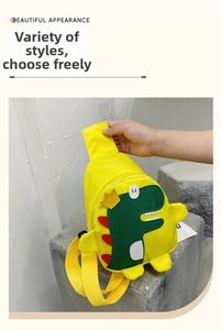 Detail of yellow nylon dinosaur kids crossbody bag with 3D crown and zipper closure