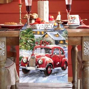Christmas table runner with vintage red car and snow cabin on a wooden festive table